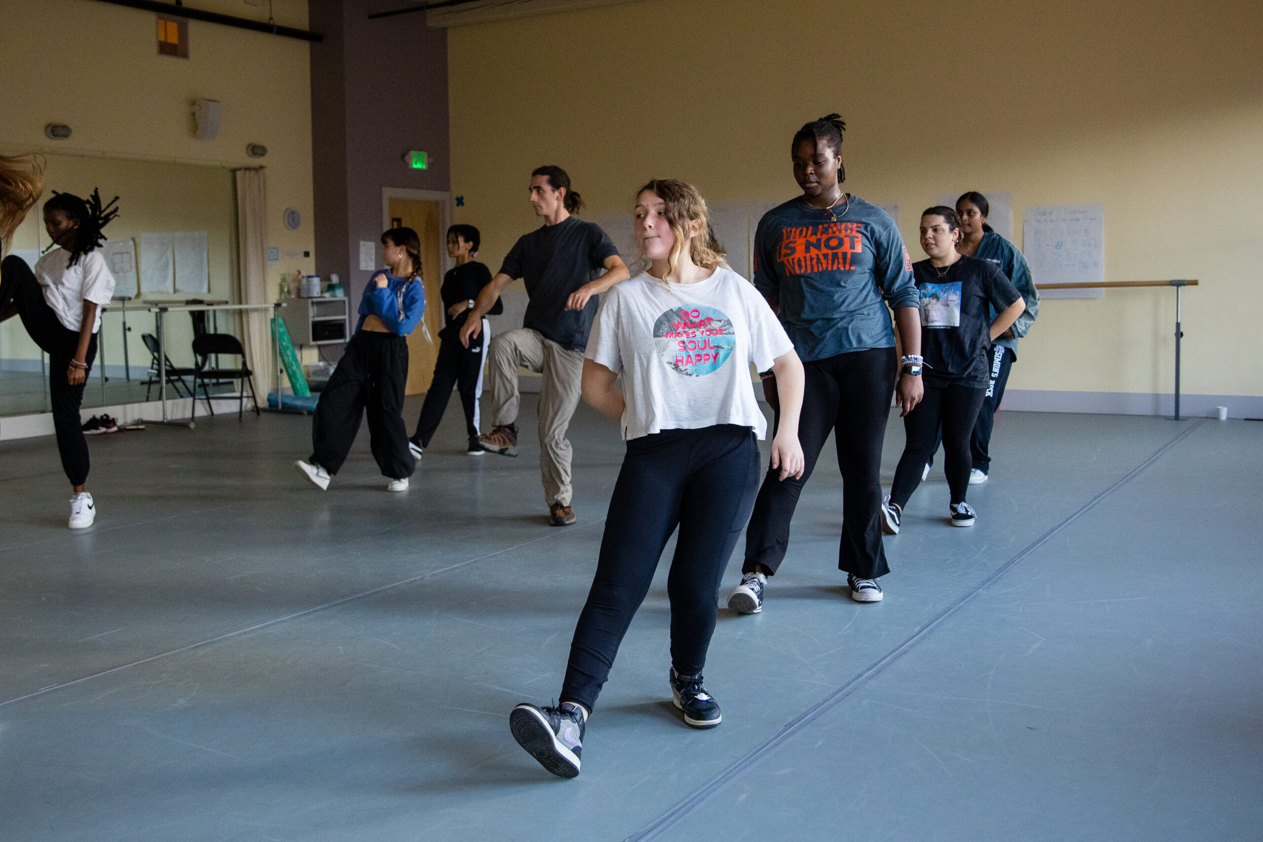 A group of dancers take a hip hop class inside a dance studio