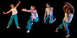 Four dancers in white tops and blue loose pants hold different shapes in movement.
