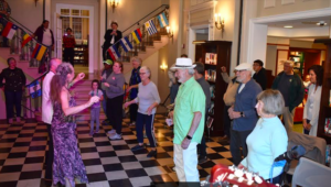 Photo of Eileen and Raul dancing in a senior center.