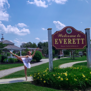 Ballerina on pointe shoes and white tutu in an arabesque by the "Welcome to Everett".
