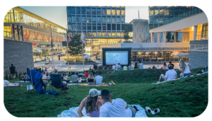 Photo of people gathering an outdoor movie showing.