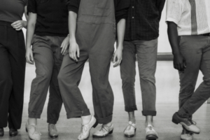 Black and white photo of tap dancers legs standing in different poses