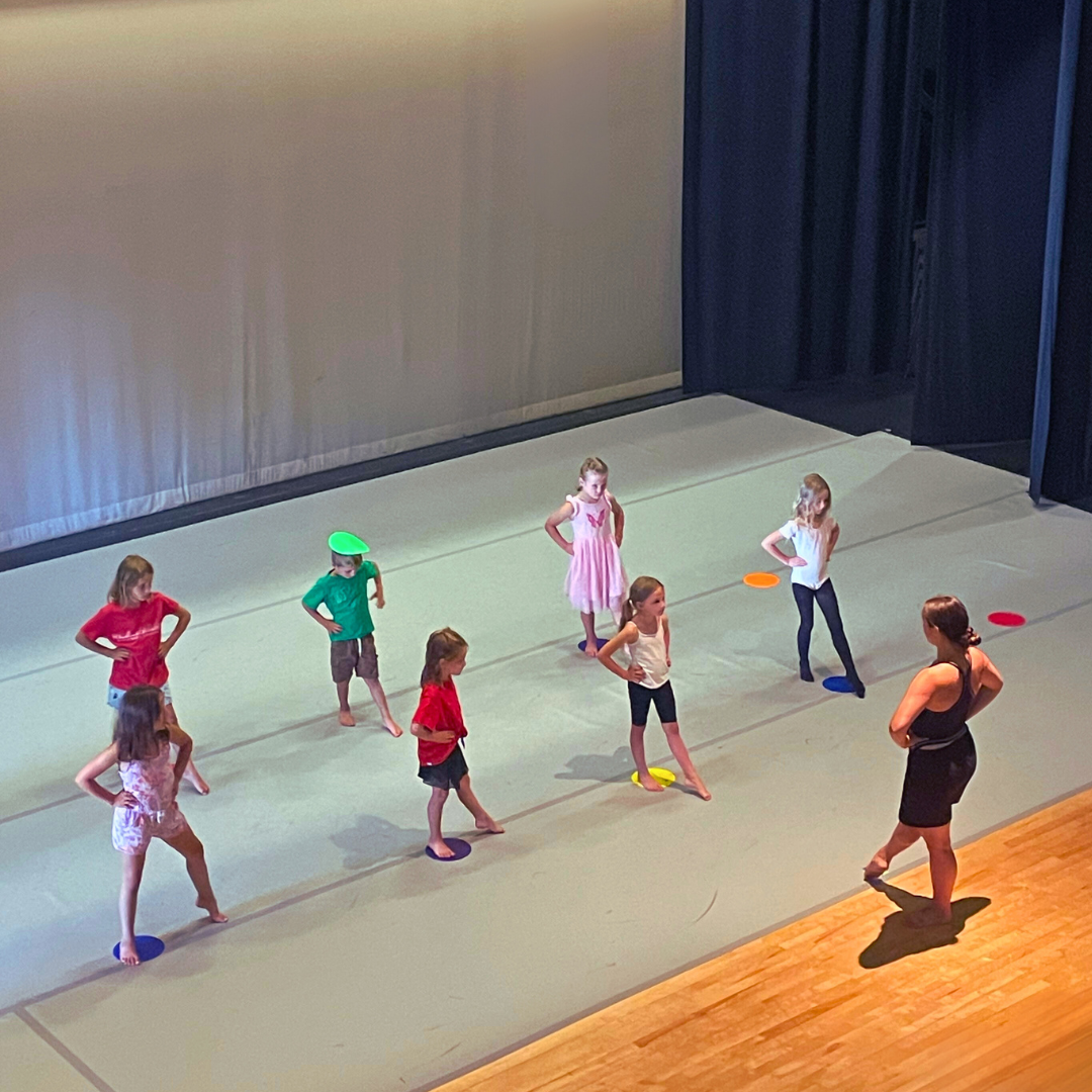 young kids learning to dance on a stage