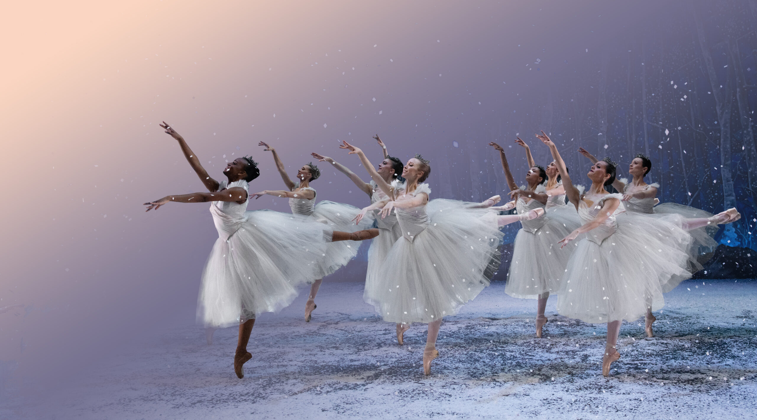 A group of dancers waltz together in front of a snowy, ombréd background.