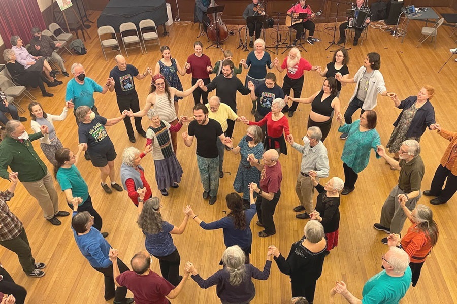 Photo of many people dancing in concentric circles