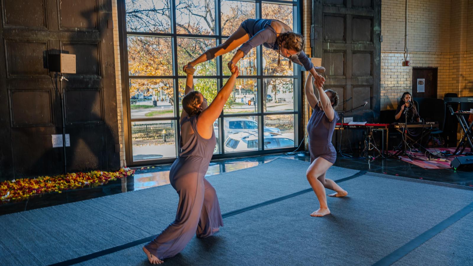 Photo of three circus artists in a lift.