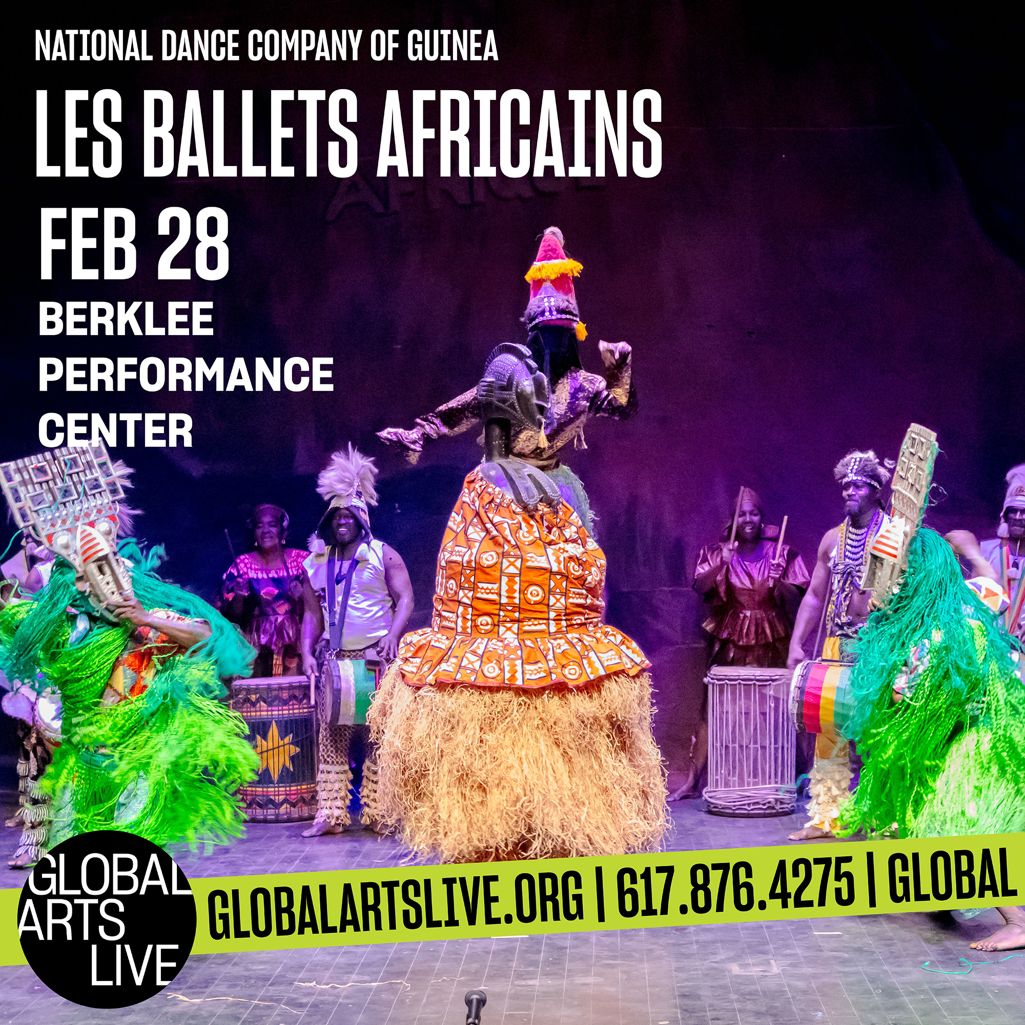Les Ballets Africains dressed in vibrant traditional clothing dance on stage.
